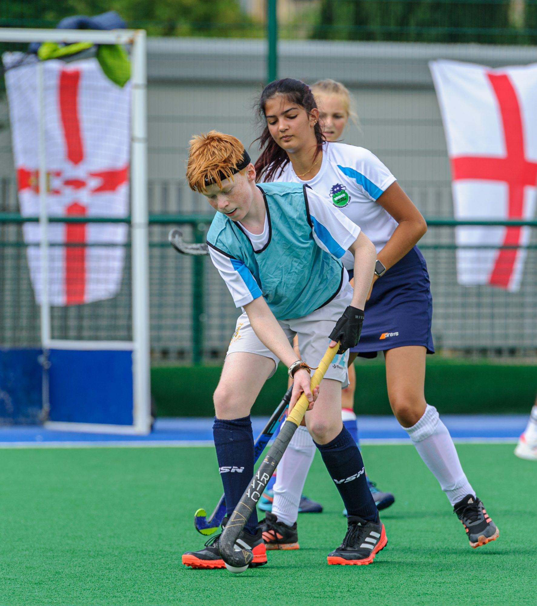 Two players contesting the ball at an EM Evolve high performance hockey camp