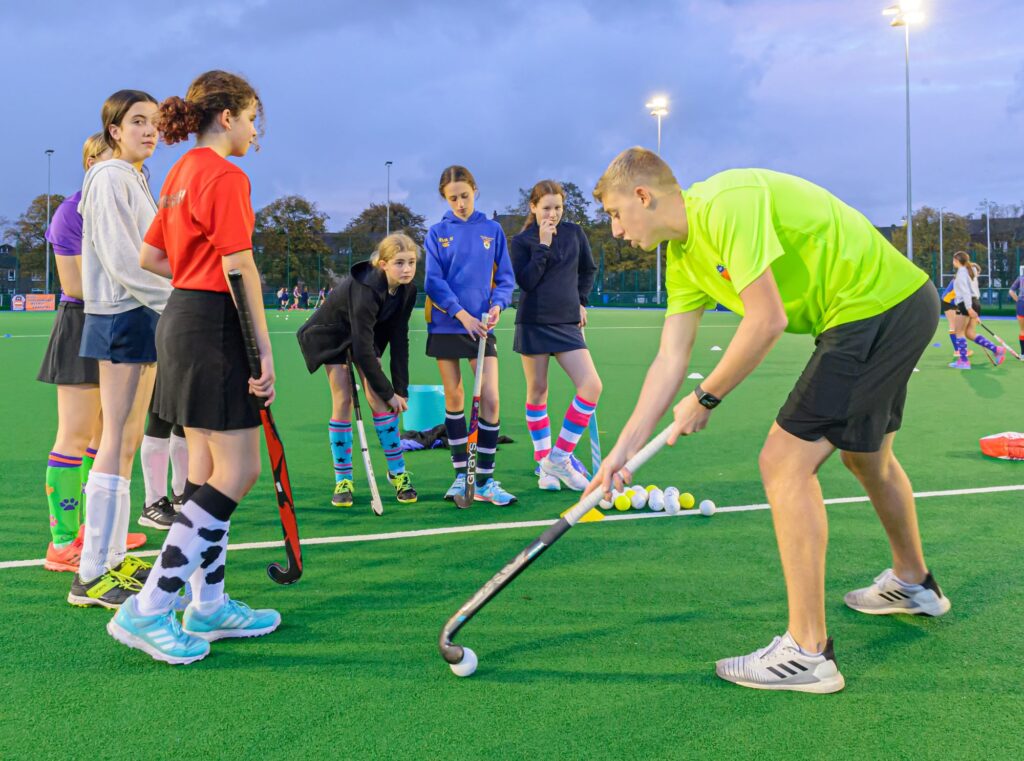 Spider Hockey coach working with a small group of players